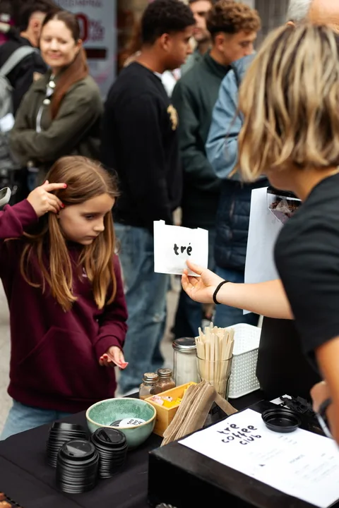 Tré Coffee Club handing out coffee at the store