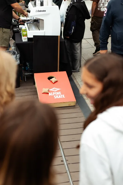 Cornhole with the Alpine Skate board on the sidewalk