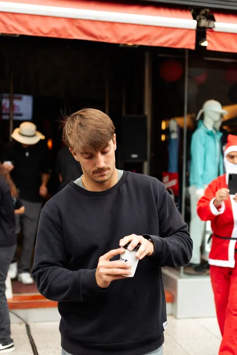A customer with his coffee outside the store